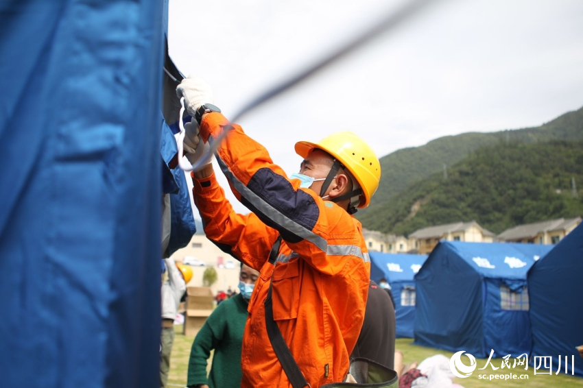 9月6日，電力搶險人員在甘孜職院安置點為新增的帳篷通電。肖順華攝