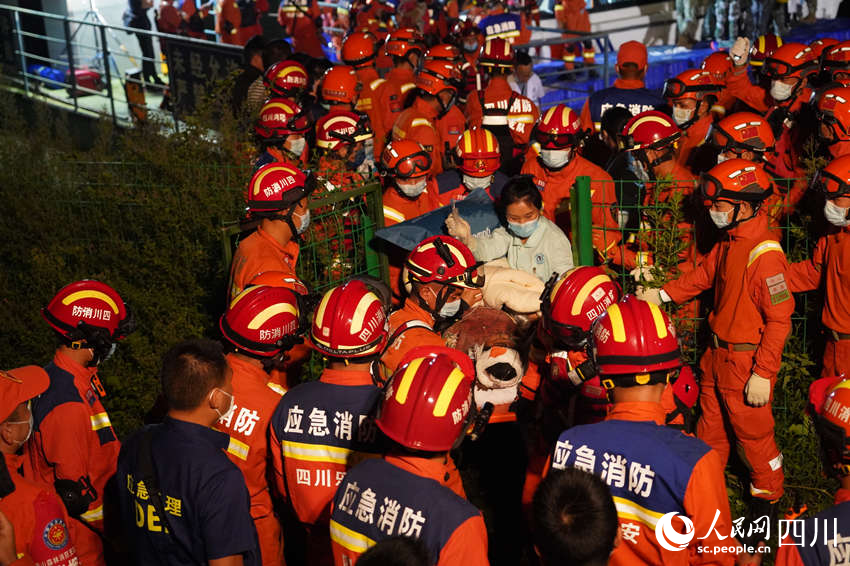 9月5日晚，雅安消防支隊(duì)在新民鄉(xiāng)碼頭，消防救援人員與多方救援力量一起運(yùn)送傷員。鄭竺青攝