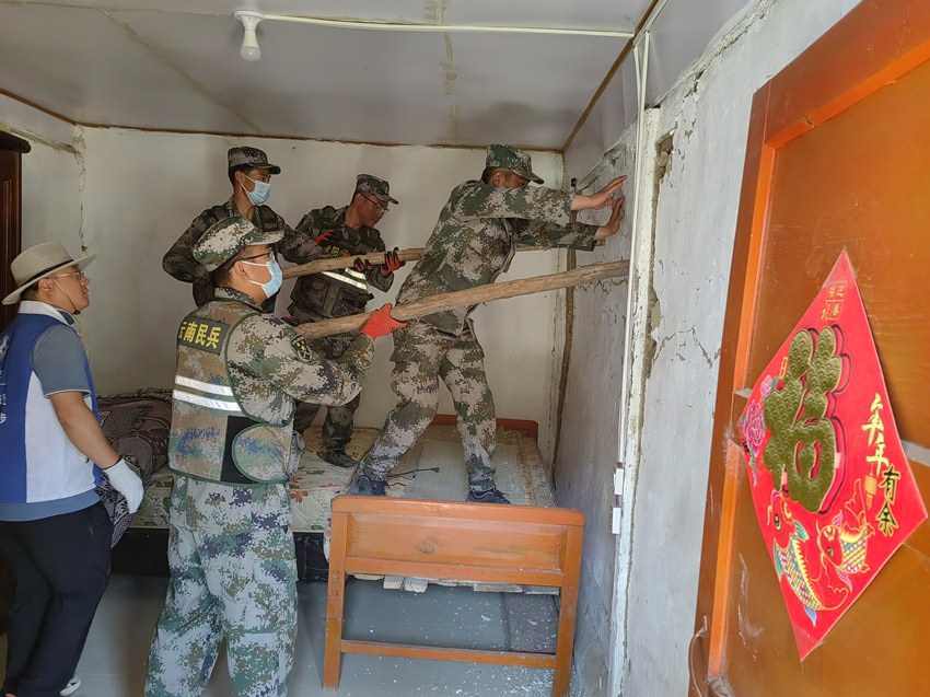 楊愛理（右一）在排除房屋安全隱患。陸軍第77集團軍某旅供圖