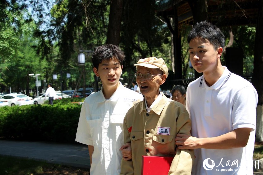 圖為川大學(xué)生迎接老兵進(jìn)校園。何香怡攝