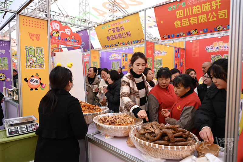 食品展位前圍滿了前來試吃的市民。廣安市融媒體中心供圖